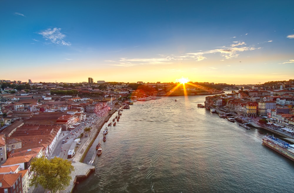 city buildings near body of water during sunset