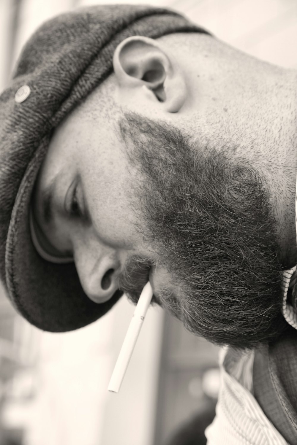 man with black beard smoking cigarette