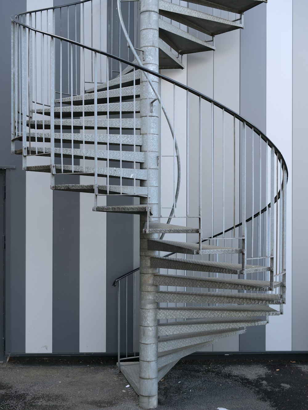 white spiral staircase with white metal railings