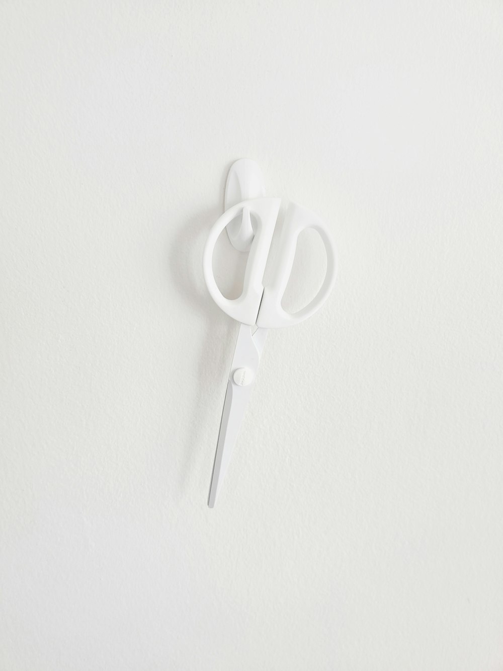 white plastic clothes pin on white surface