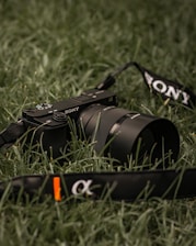 black nikon dslr camera on green grass