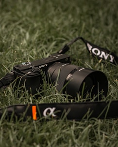 black nikon dslr camera on green grass