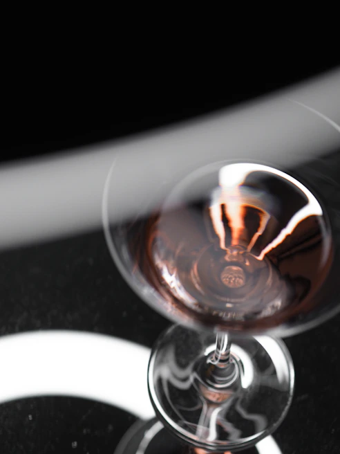 Close-up of a glass of rich Greek red wine catching the light