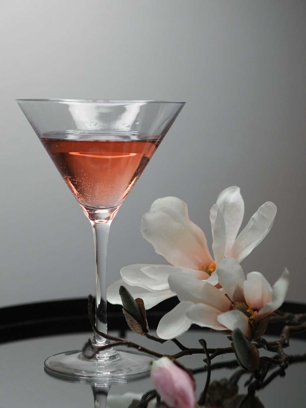 clear drinking glass with red liquid on black table