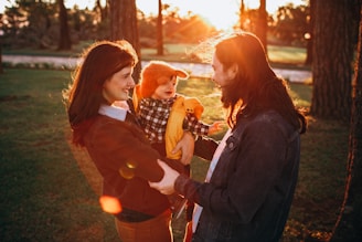 A serene family moment in a sunlit park.