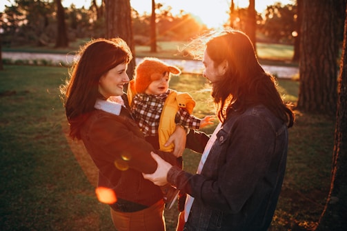 A serene family moment in a sunlit park.
