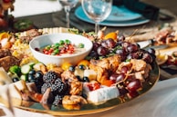 A colorful spread of fresh salads and dips in small bowls.