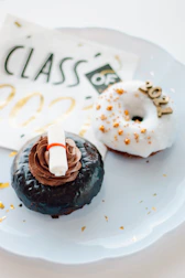 Elegant chocolate dipped treats styled with graduation caps and scrolls.