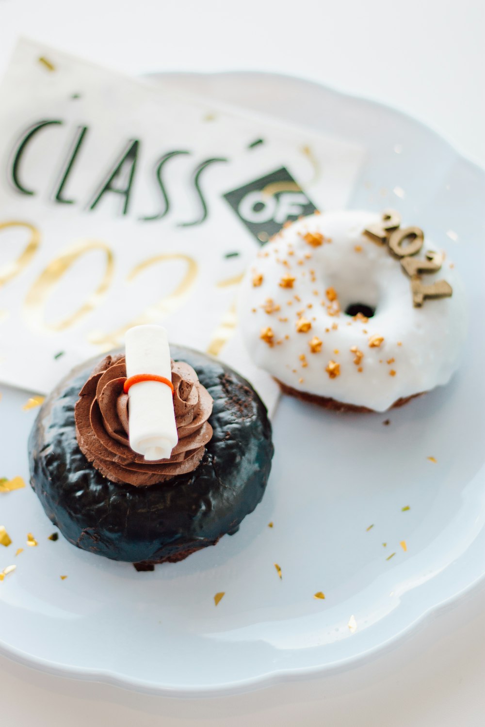 chocolate cupcake with white icing on white ceramic plate