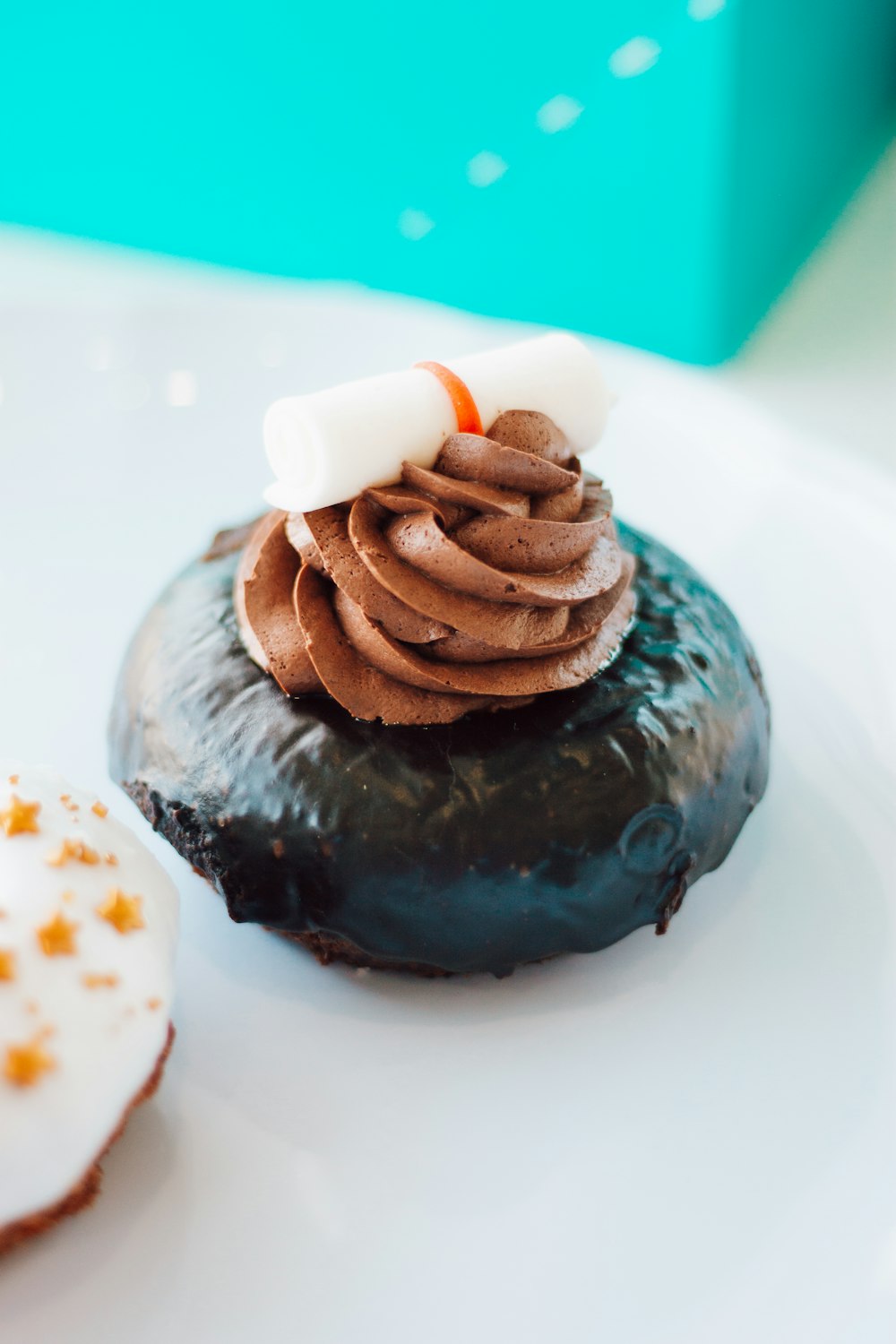 chocolate cake with white icing on white ceramic plate