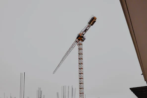 Steel fixers reinforcing concrete structures with Dubai cranes visible behind.