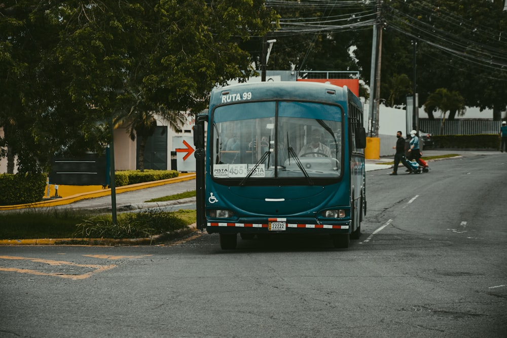 blue and white bus on road during daytime