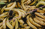 yellow banana fruit on white and pink rope