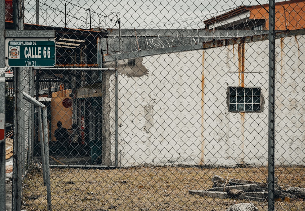 white metal fence near brown concrete building during daytime