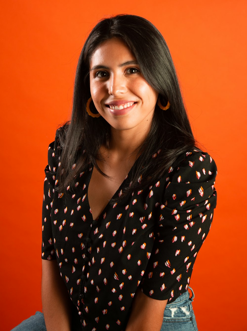 woman in black and white polka dot shirt smiling