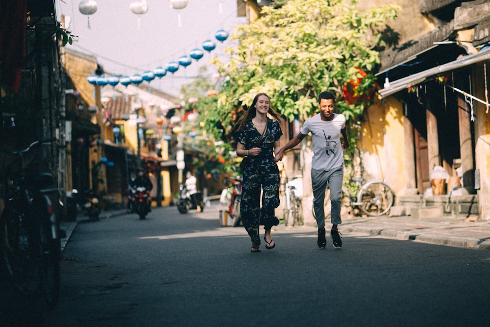 man and woman walking on street during daytime