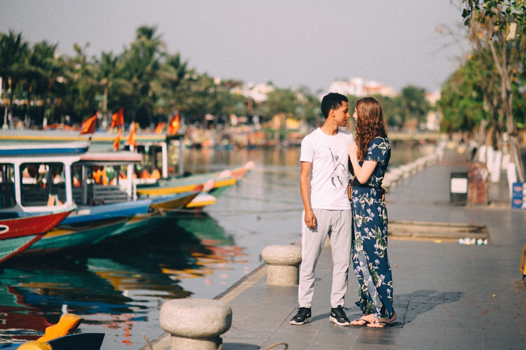 couple standing on dock during daytime