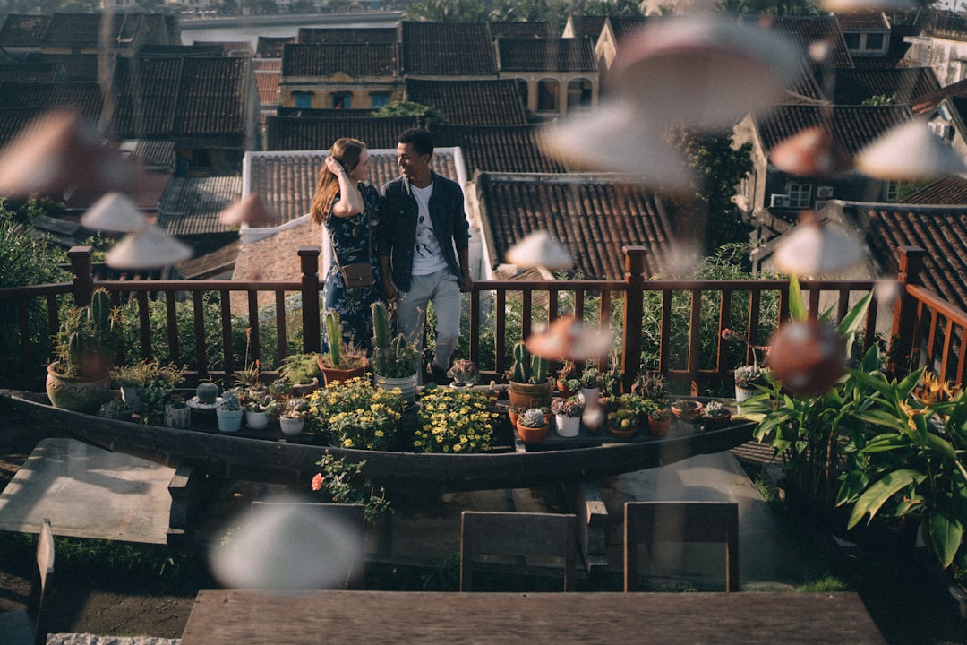 woman in black jacket standing near green plants during daytime