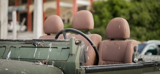 Close-up of olive green waterproof tarpaulin fabric stretched over a military vehicle.