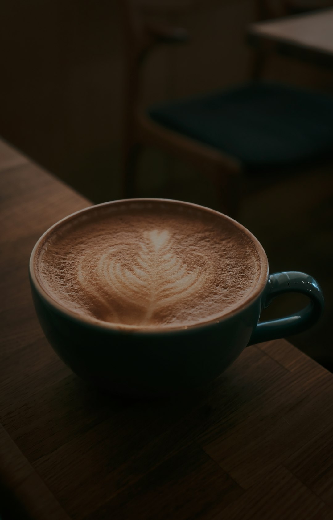 black ceramic mug with heart shaped coffee