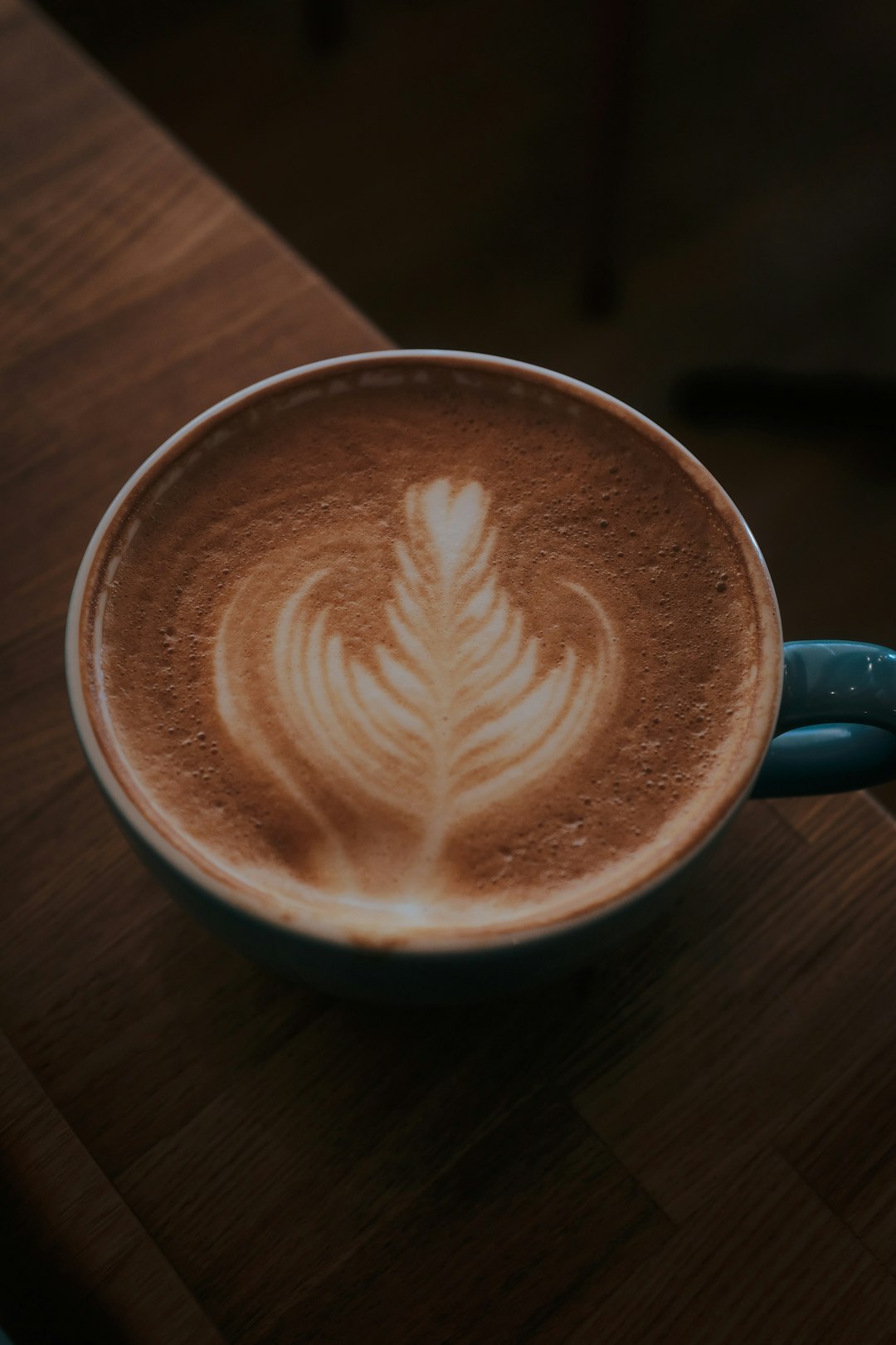 black ceramic mug with heart shaped coffee