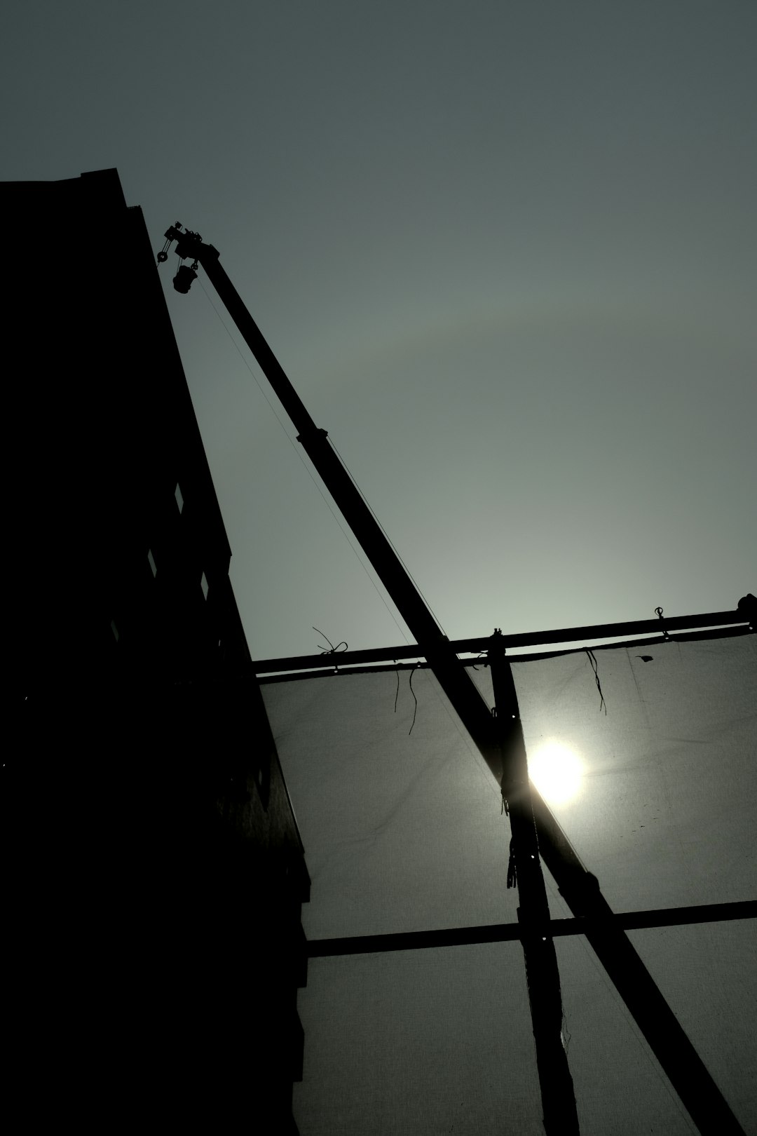 silhouette of person standing on top of building during sunset