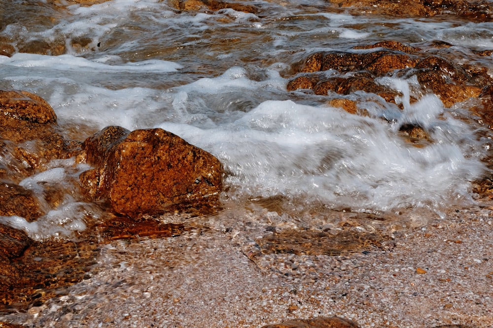 brown rock on seashore during daytime