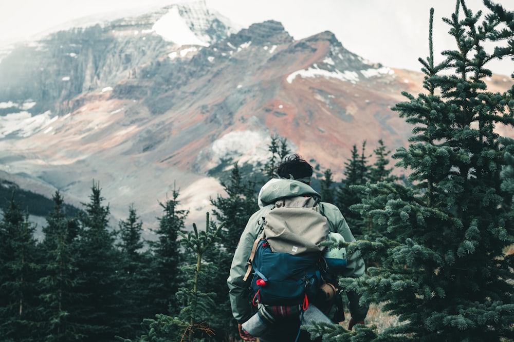 a person with a backpack walking up a hill