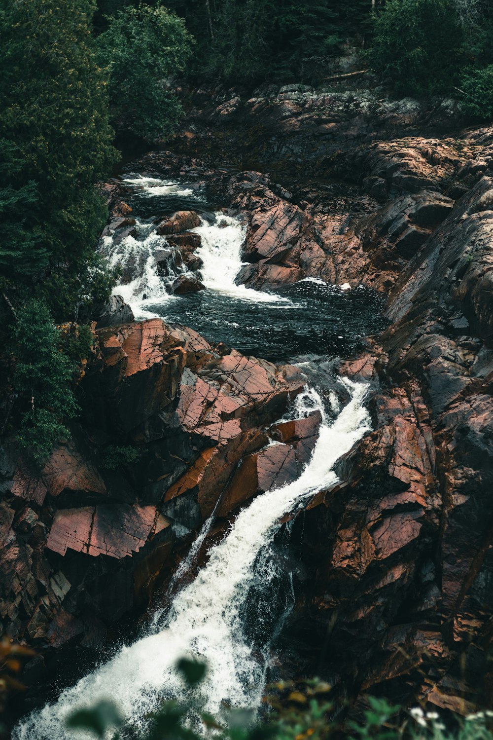 water falls in brown rocky mountain