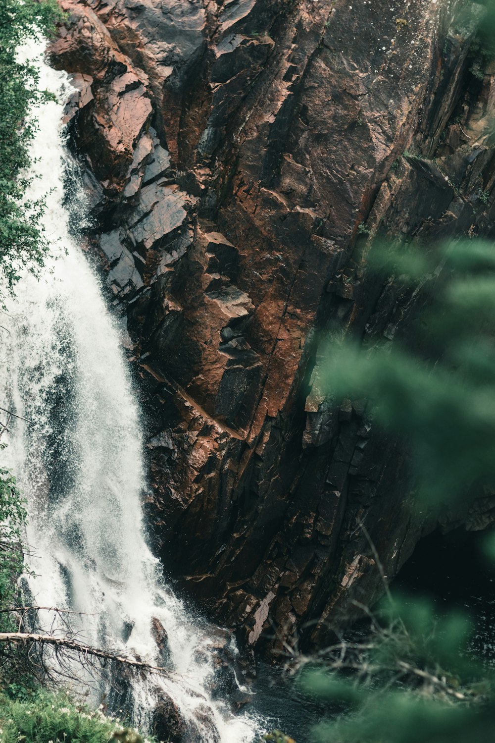 water falls on brown rocky mountain