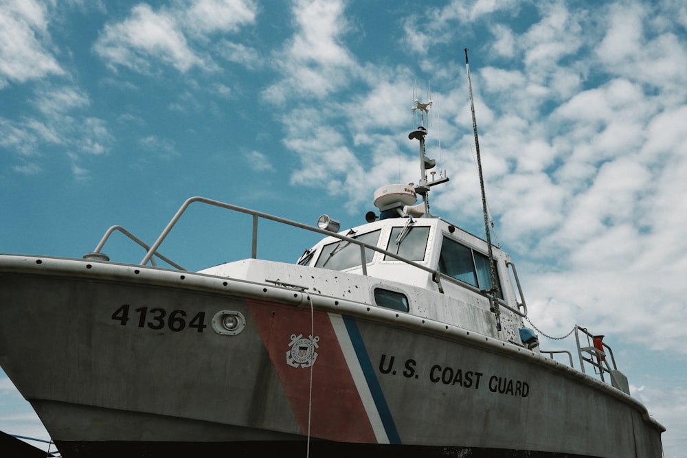 white red and blue boat on sea during daytime