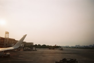 Various ground support equipment lined up on airport tarmac.