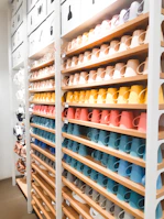 Bright and colorful ceramic mugs organized in a cheerful pattern on a kitchen counter.