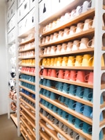 Colorful display of various household items including mugs, pots, and cute toys arranged neatly on a white background.