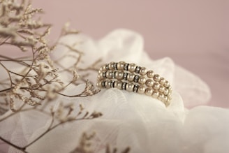 gold and white pearl accessory