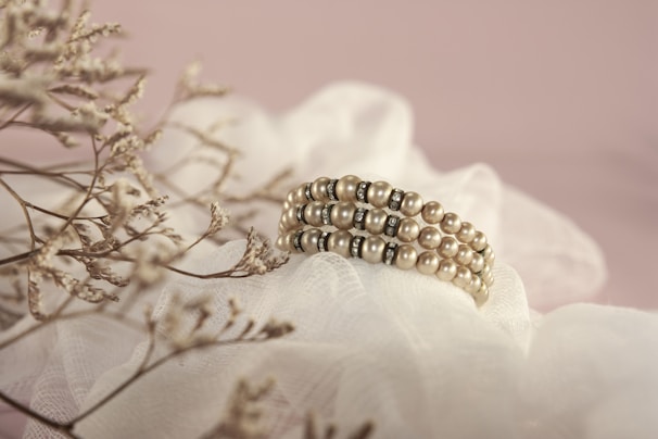 gold and white pearl accessory