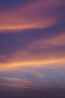 A serene purple and gold cosmic sky blending into a tranquil vastu-inspired home interior.