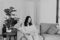 A person comfortably applying for a loan online from home using a laptop.