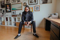 A stylish office setting featuring a man wearing a tailored jacket and trousers.