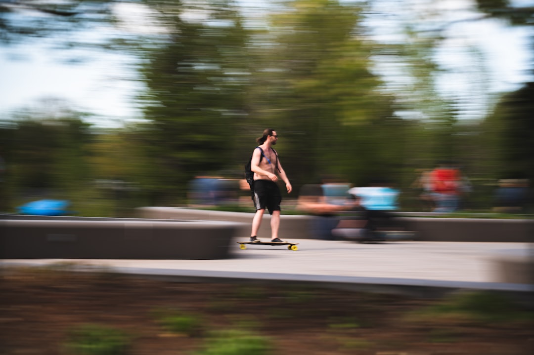 woman in black dress running on road during daytime