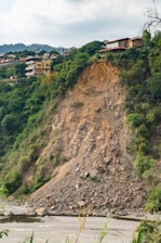brown and white concrete building on hill