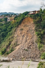 brown and white concrete building on hill