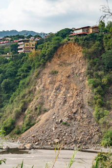 brown and white concrete building on hill