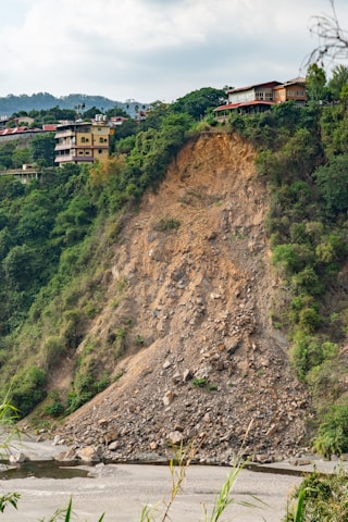 brown and white concrete building on hill