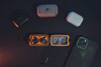 A vibrant display of colorful smartphone cases and wireless earbuds arranged neatly.