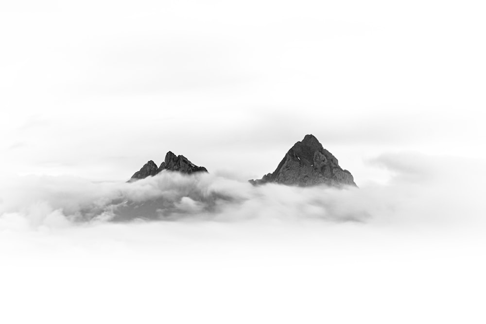 black and white mountain under white clouds