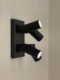 Spotlight fixtures casting focused beams on minimalist artwork.