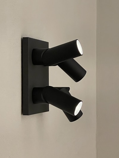 A modern LED spotlight illuminating a dark room corner.