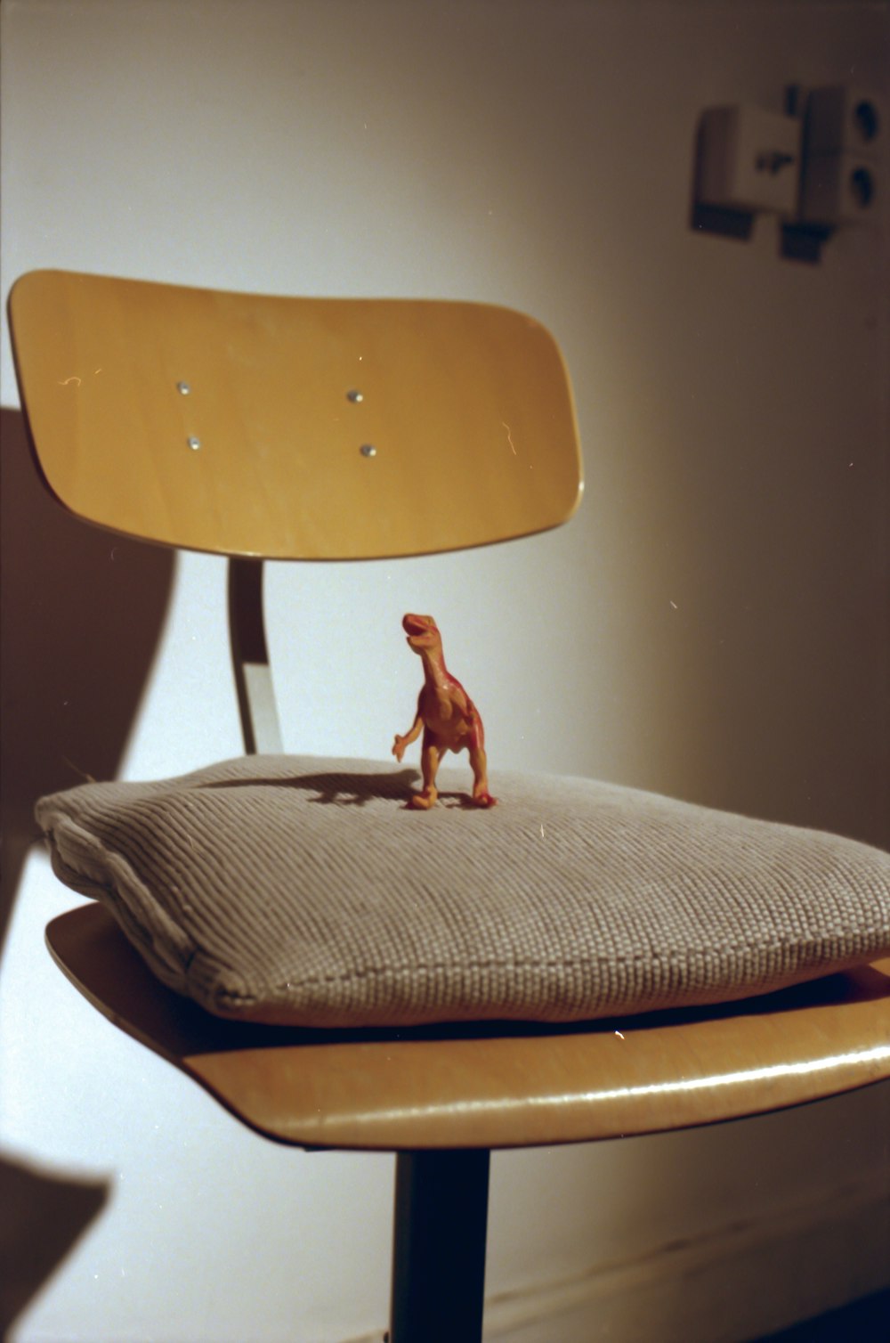 brown dog figurine on brown wooden chair