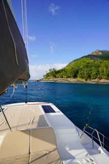 Handcrafted marine boat cushions in rich navy blue fabric on a sunny deck.
